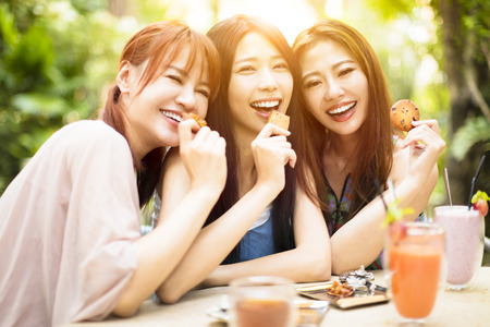 Group of young woman laughing in restaurantの写真素材