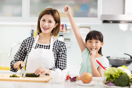 Happy mother and daughter cooking in the kitchen
の写真素材