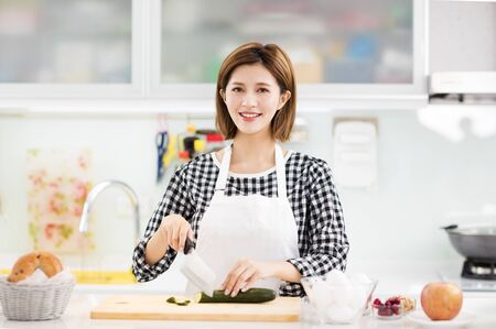 smiling Young Woman Cooking in the kitchen
の写真素材