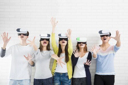 Young group having fun with new technology vr headset