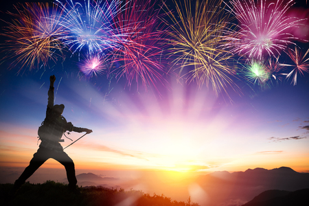 man on the mountain and watching sunrise and fireworksの写真素材