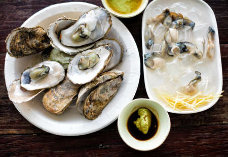 Opened and fresh Oysters on the table