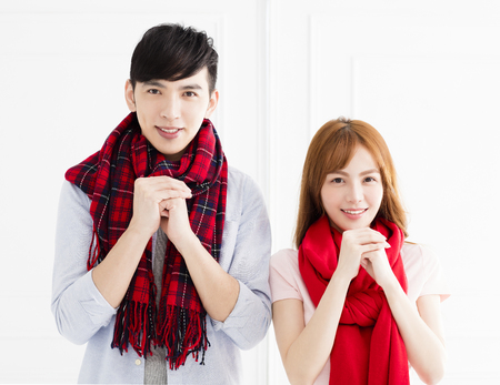 happy asian couple with congratulations gesture for chinese new yearの写真素材