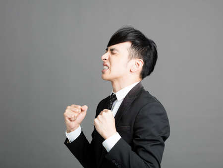 Young business man stressed and angryの写真素材