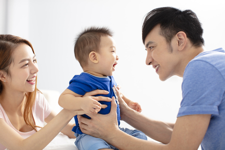 Portrait of young happy family with babyの写真素材