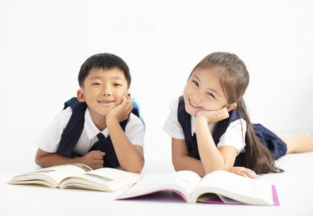 happy little boy and girl student studying togetherの写真素材