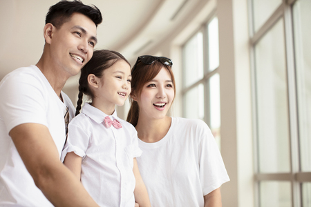 happy family looking through the windowの写真素材