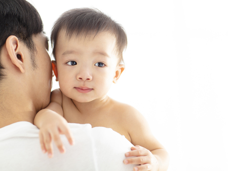 father holding  cute baby on shoulderの写真素材