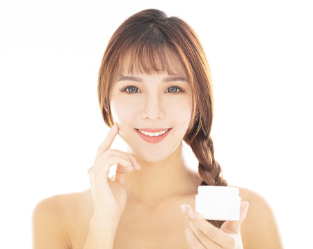 closeup young  beauty face showing skin care productの写真素材