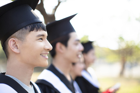 smiling asian young man at graduationの写真素材