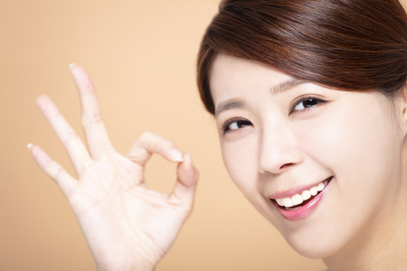 happy Beautiful girl  with ok gestureの写真素材