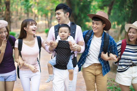 Group of young people with backpacks walking togetherの写真素材