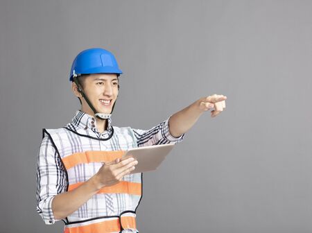 smiling asian young man construction workerの写真素材