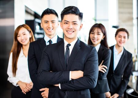 confident asian business team stands in officeの写真素材