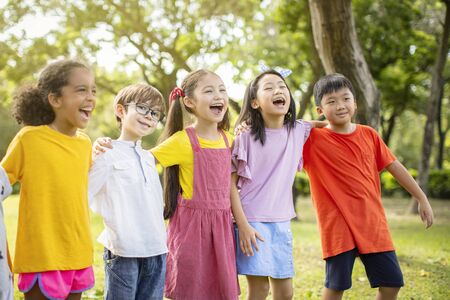 Multi-ethnic group of school kids laughing and embracingの写真素材