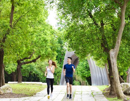 happy young Couple jogging and running  in parkの写真素材