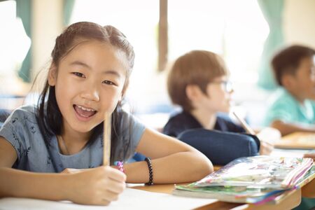 Smiling elementary school kids  in classroom