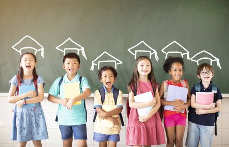 Group of diverse young students standing together in classroomの写真素材