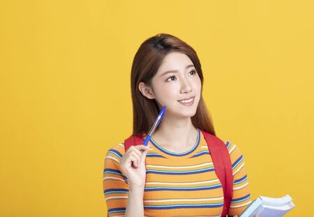 Portrait of beautiful asian  student holding booksの写真素材