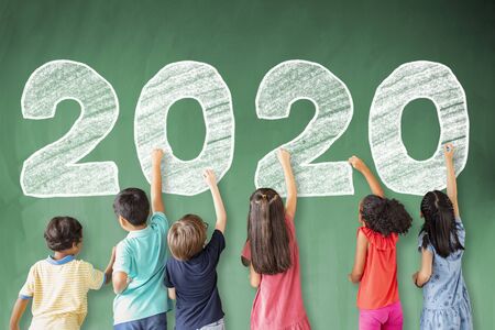 school children drawing 2020 new year on the chalkboardの写真素材