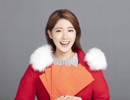 Young asian Woman in winter clothes celebrating chinese new yearの写真素材