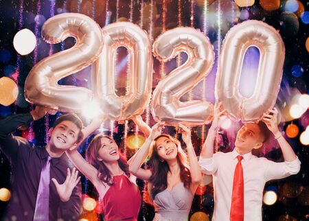 happy young group celebrating new year 2020 partyの写真素材