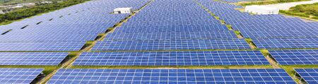 aerial view of solar panels on grass
