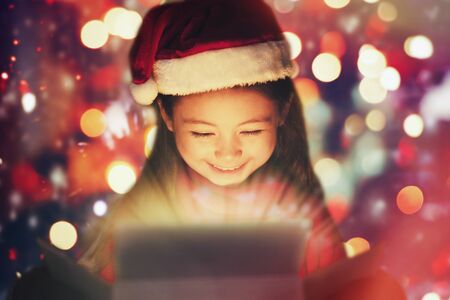 closeup smiling  little girl watching the christmas presents.の写真素材