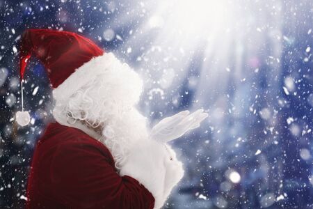 Santa Claus with magic Christmas lightsの写真素材