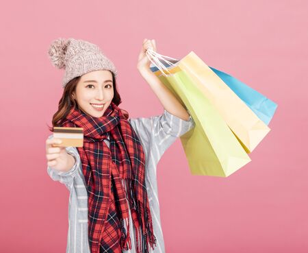 Happy young woman with shopping bags. Winter saleの写真素材