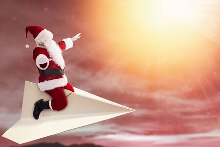 happy santa claus  on paper plane and  flying in the skyの写真素材