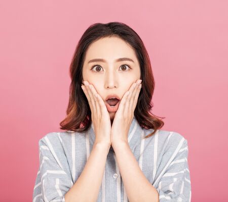 Shocked and surprised girl screamingの写真素材