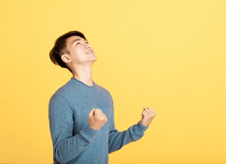 excited young  man  looking upの写真素材