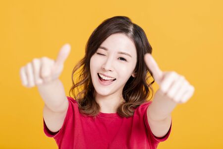 Closeup of Smiling Woman Making thumbs up  Gestureの写真素材