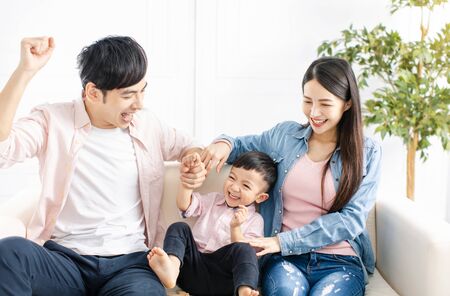 happy Family playing and  sitting on the sofa in the living roomの写真素材