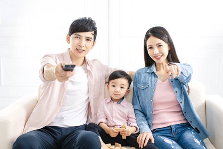 happy family watching the tv  on sofa