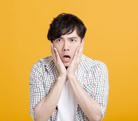 Closeup  of shocked and surprised young manの写真素材