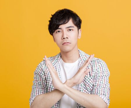 young man Refuse gesture, crossed handsの写真素材