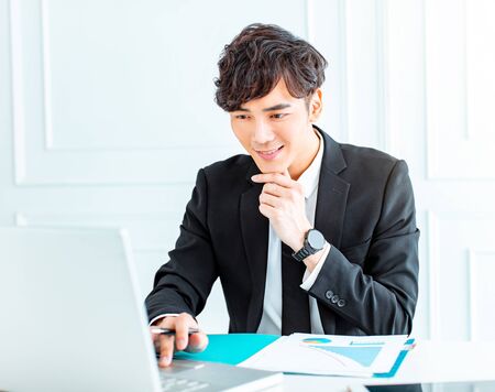 young man sitting at his desk in the office