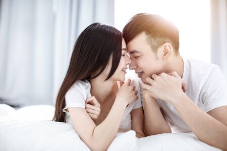 Loving couple on the bed in the bedroom