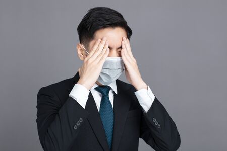 young man wear medical mask and  headache  conceptsの写真素材