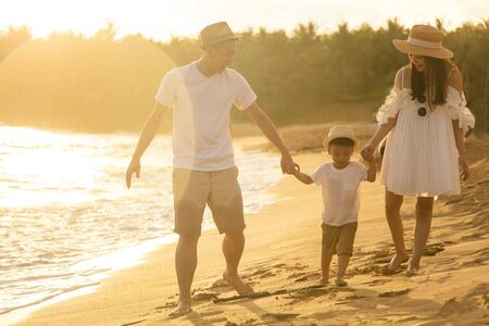 Happy family  Having Fun walking on the Beachの写真素材