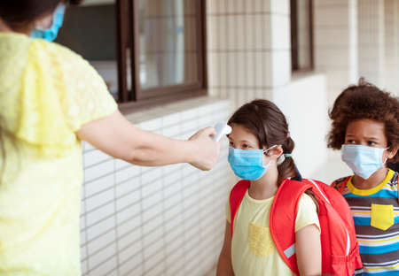 Temperature and medical check at school for covid-19の写真素材