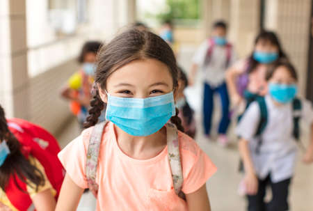 children wearing face medical mask back to school after covid-19 quarantineの写真素材