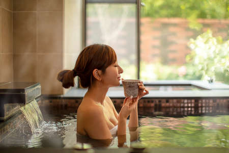 Asian Young woman relaxing in hot springの写真素材
