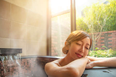 beautiful Young woman relaxing in hot springの写真素材