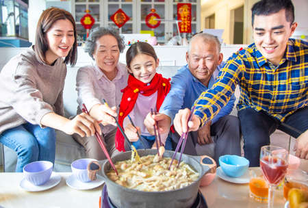 happy asian family having dinner and celebrating chinese new year at homeの写真素材