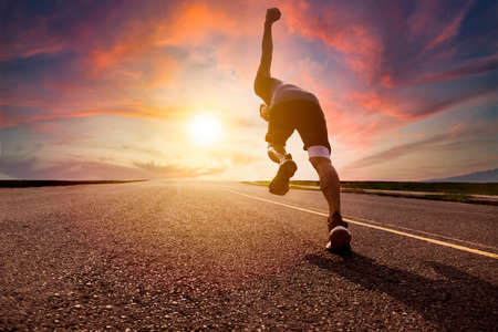 man in face mask and running in the parkの写真素材