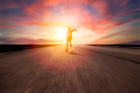 man running and sprinting on road with sunset background