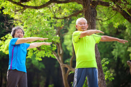 Asian Senior Couple jogging in the nature park